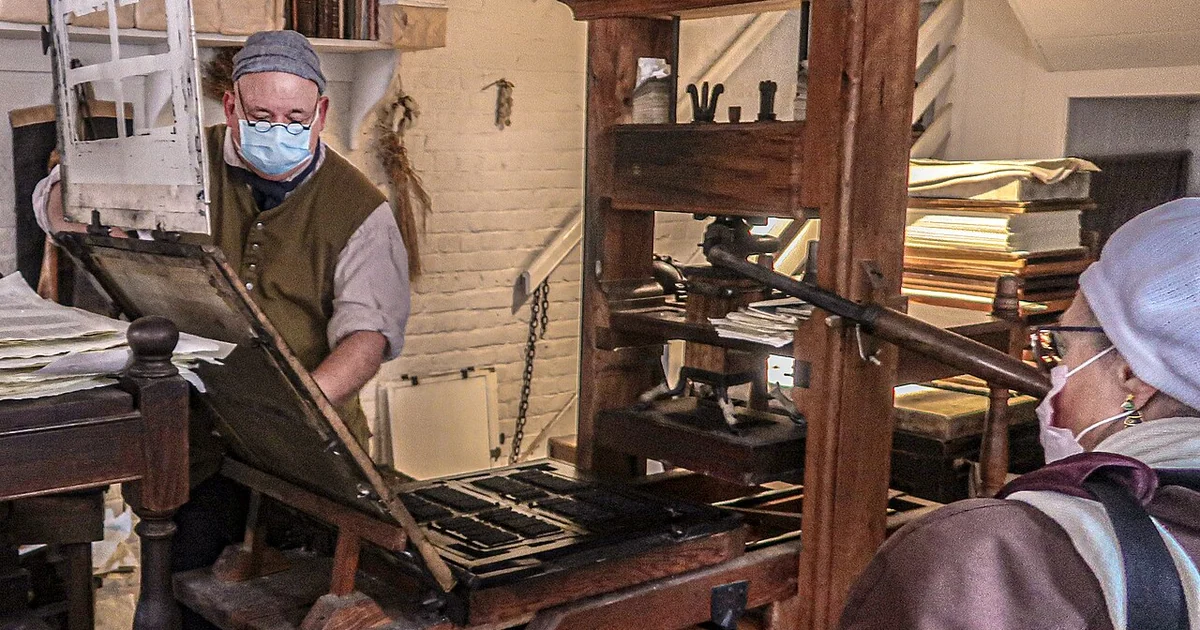 Printers set type and use printing presses to manufacture colonial newspapers, political notices, pamphlets and books -- Colonial Williamsburg, Virginia