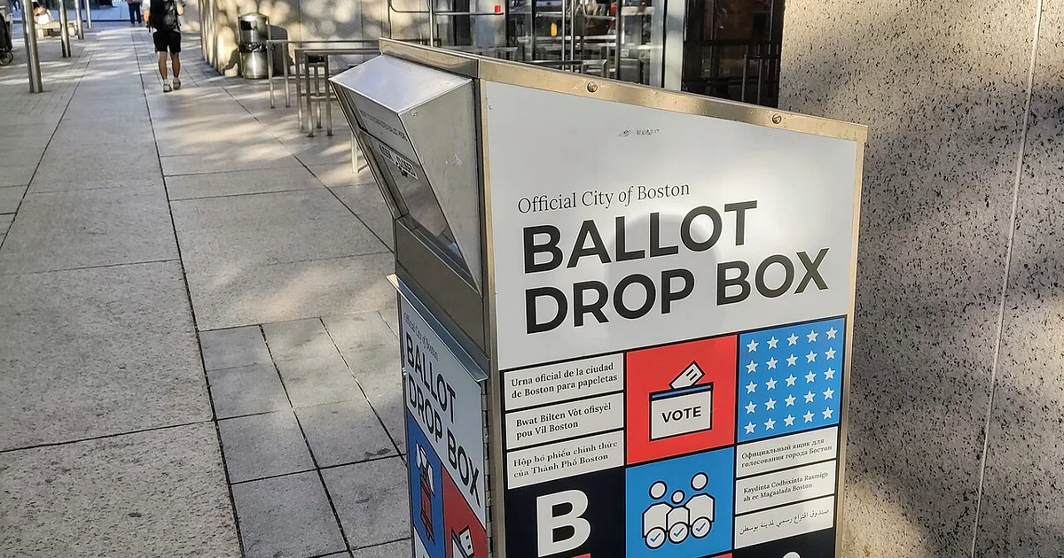 A white, blue, and red ballot drop box used for early voting in the city of Boston, Massachusetts.